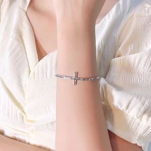 Elegant 925 sterling silver bracelet with textured horizontal cross on female wrist