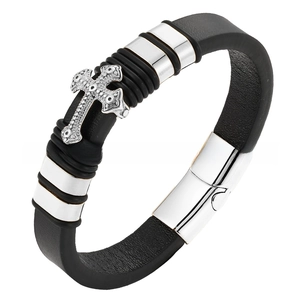 Detail of black leather bracelet with silver steel cross pendant and magnetic clasp