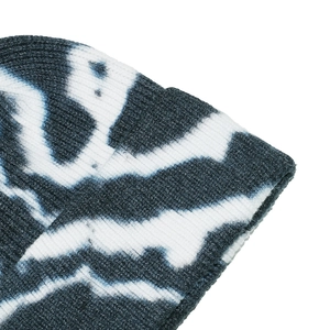 Detailed close-up showing the blue and white tie-dye ribbed knit texture of the beanie
