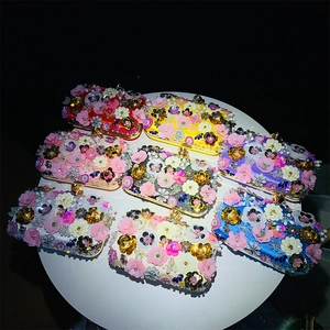 Top view of eight colorful handmade beaded evening bags with 3D floral and sequin details