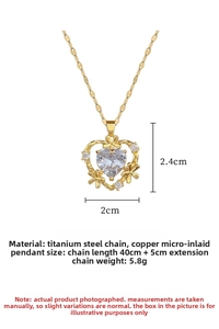 Detail view of heart pendant with zirconia and dimensions of 2.4cm by 2cm on gold chain
