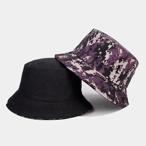 Detail view of cotton bucket hats in solid black and purple digital camouflage patterns
