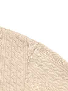 Detailed macro view of beige knit fabric texture and stitching on men's V-neck sweater