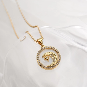 Macro detail of gold necklace with crescent moon and star pendant inlaid with zircons