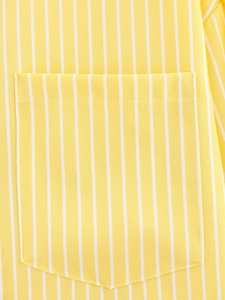 Detail of a yellow and white striped shirt showing the pocket and fine stitching