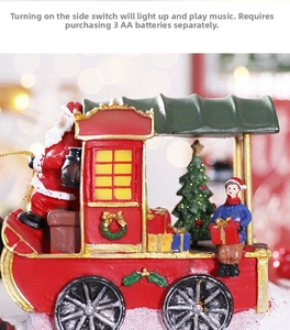 Close-up of lighted musical Christmas train with Santa and tree featuring warm LED glow