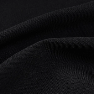 Close-up of premium black rib-knit fabric texture with detailed elastic stitching
