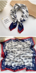 Detail of silk square scarf featuring vintage carriage print and contrast rolled edges