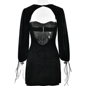 Detail of the open back velvet dress with lace-up cuffs and central metal hardware
