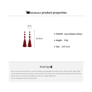 Detail view of red velvet beaded tassel earrings with size dimensions and weight info