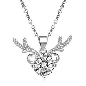 Macro detail of silver reindeer antler pendant necklace with a brilliant round-cut solitaire