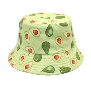 Reversible bucket hat featuring avocado fruit print in a light green summer style