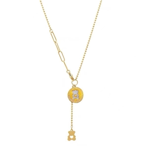 Fashionable gold bear necklace with bead and paperclip chain on white background