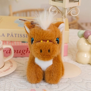 Detail of cute brown plush pony keychain with soft fur texture and embroidered eyes
