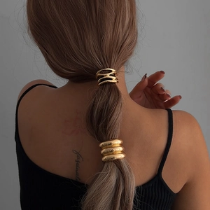 Minimalist gold alloy geometric hair ties with layered circular design on model