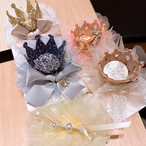 Detail of glitter princess crown hair clips with lace tulle and faux pearl embellishments