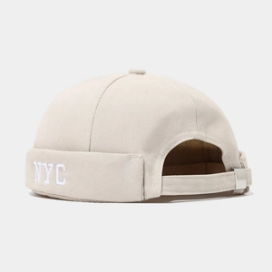 Detail of NYC embroidery and adjustable metal buckle on beige vintage miki hat