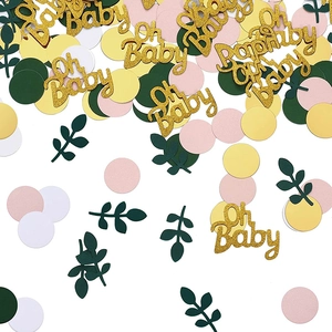 Mix aus glitzerndem Oh Baby Text in Gold mit grünen Blättern und buntem Konfetti