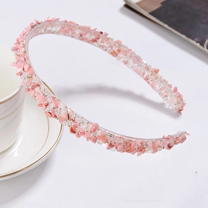 Macro shot of pink sequin headband with golden beads and sparkling finish details