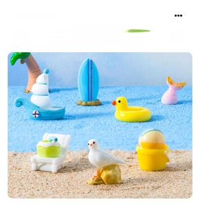 Miniature resin beach set featuring tiny sailboat, surfboard, and beach chairs for DIY decor