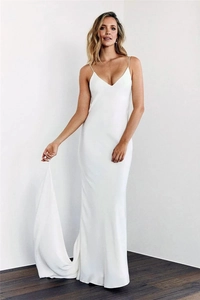 Detail of elegant white satin spaghetti strap evening gown with deep V-neck and flowing train