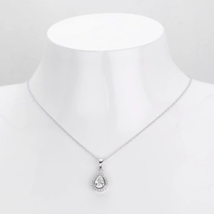 Detailed macro shot of the water drop pendant with sparkling pavé stones and silver chain