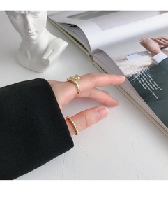 Dettaglio dell'anello a goccia d'oro minimalista e fascia con perline su modella