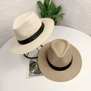 Classic white and beige Panama straw hats with black ribbon for summer sun protection