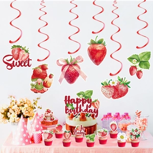 Detail of strawberry party decorations including cake toppers and hanging swirl cards