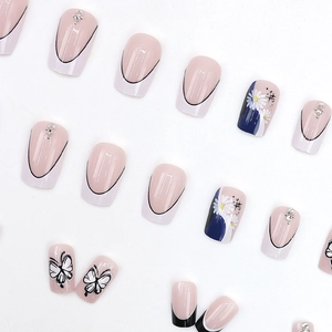 French style press-on nails with butterfly, floral prints, and rhinestone accents
