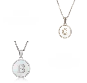 Detail showing shell-inlaid stainless steel alphabet pendant with high-polish finish