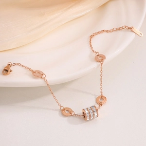 Rose gold stainless steel bracelet with roman numeral rings and sparkling diamond pendants