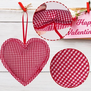 Detail of red and white checkered fabric heart ornaments with silk hanging ribbons
