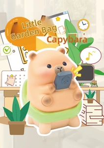 Cute Capybara resin figure holding a controller in a creative office desk scene