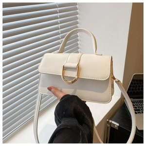 Close-up of white PU leather bag featuring a gold D-buckle and elegant top handle