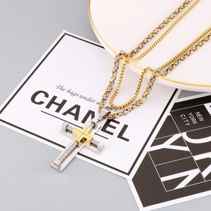 Detail of cross pendant with steel cable texture and two-tone double layer chain