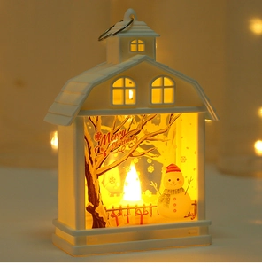 Macro detail of Christmas house lantern with snowman scene and warm LED light effect