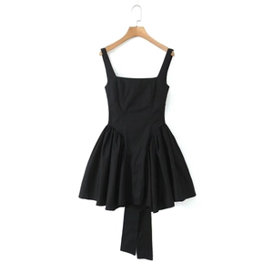 Detail of the back tie-up bow and high waist pleated skirt on a black sleeveless dress