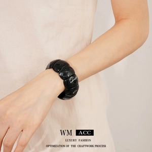 Minimalist black marble acrylic geometric cuff bracelet for women shown on wrist