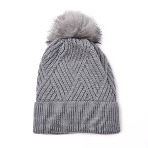 Women's grey knit beanie with warm fleece lining and a fluffy faux fur pompom detail