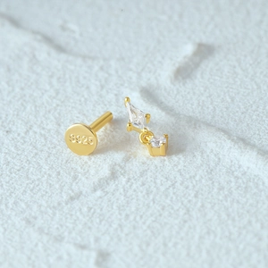 Macro detail of gold 925 sterling silver ear stud with clear S925 hallmark and crystals