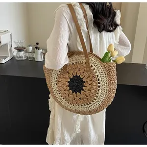 Detail shot of handcrafted paper rope woven beach bag with sunflower pattern and leather handles