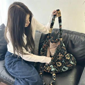 Detailed view of the plush vintage tote bag featuring colorful geometric knit patterns
