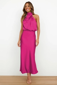 Detail of elegant magenta satin halter neck maxi dress showing fabric drape and texture