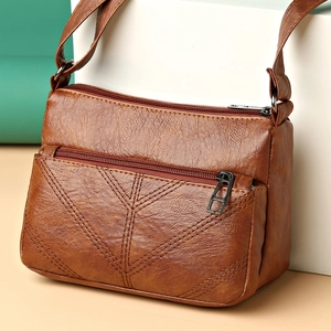 Brown PU leather shoulder bag for women with multiple zip pockets and adjustable strap