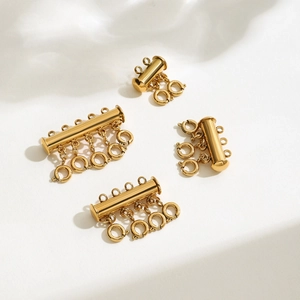 Macro shot of 18k gold plated multi-strand layered necklace clasps and connectors