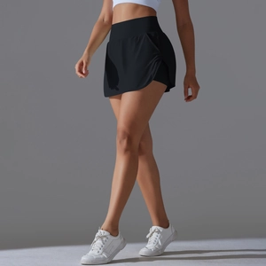 Detail view of high waisted black tennis skort showing side slit and athletic fabric
