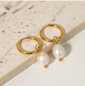 Detail of vintage French style gold hoops with white irregular freshwater pearls