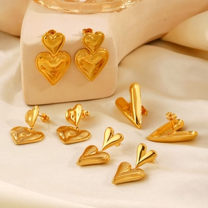 Fashionable 18K gold-plated double heart earrings set displayed on soft satin fabric