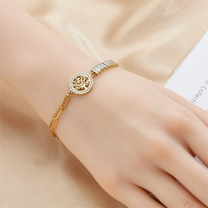 Elegant gold titanium steel bracelet featuring a tree of life pendant on champagne silk